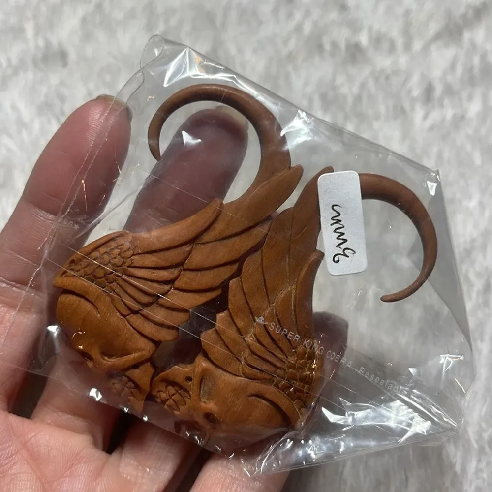 Hanging skull and wings wood carved gauges hanging